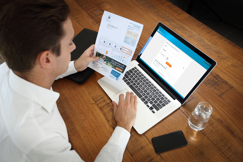 Business owner reviewing finances on a laptop