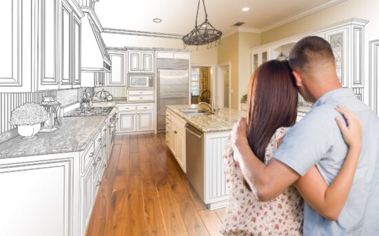 Couple embracing, admiring their new kitchen.
