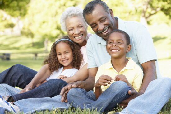 Grandparents in a park with their grandchildren.